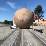 Large storage tank hauled by trailer truck