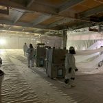 Construction workers wearing protective equipment during asbestos removal